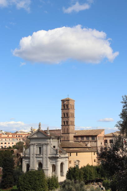 Captivating view of historic architectural buildings along Via del Corso in Rome, Italy. The photo emphasizes the beauty and details of traditional Roman architecture, featuring distinctive windows, facades, and rooftops beneath a moody, cloudy sky. Perfect for conveying the atmosphere of classic Roman urban scenes and historical European streets.