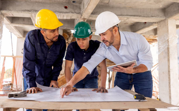 istock Architect discussing a blueprint with the building contractors 2157325542