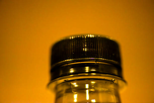A close-up reveals the intricate texture and details of a plastic bottle cap, highlighting environmental concerns.