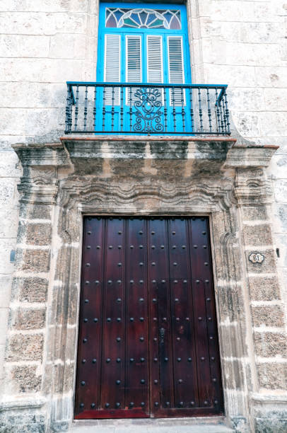 Door on a old building with a balcony above in Old Havana, Cuba.