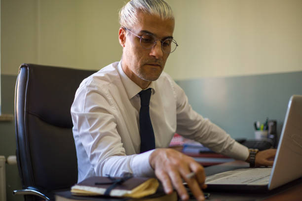 istock businessman working with computer and having a job interview in the office 2157333090