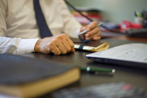 Businessman in formal wear navy blue tie working with computer and having a job interview in office