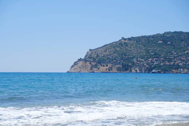Mediterranean seaside coast in calm weather on blue sky background. High quality 4k footage