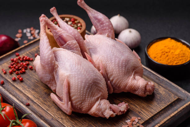 istock Whole raw quails with salt, spices and herbs on a dark concrete background 2157339737