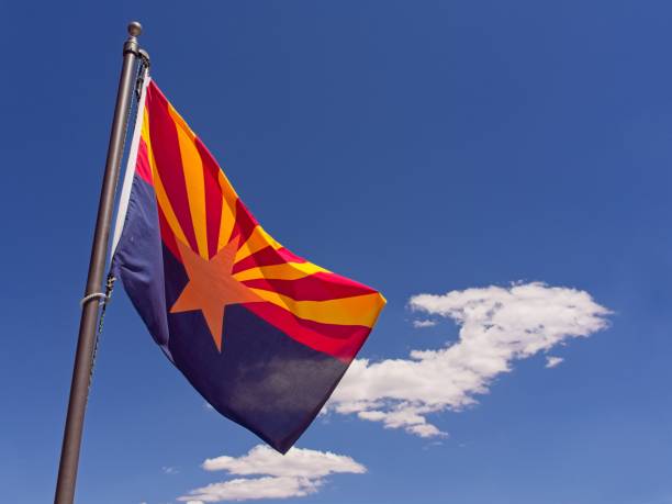 istock Arizona state flag against a bright blue sky 2157340062