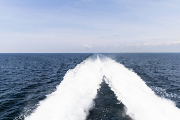 Water trail behind cruise ship. Summer travel concept. High quality photo