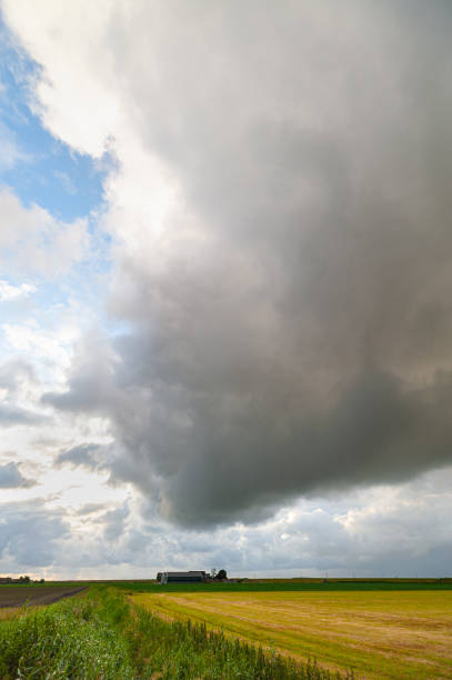 istock Tall thunder cloud over a distant farm on the plains 2157341026