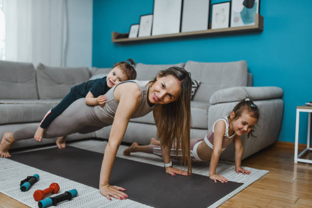istock Strong Mother Demonstrating Plank Exercises With Daughters 2157342254