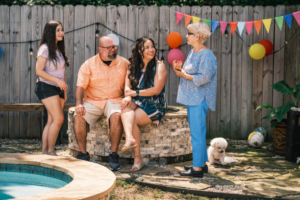 istock Latino family members taking a break at the backyard party 2157342829