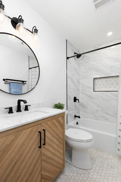 istock A bathroom with a white oak cabinet and hexagon tile flooring. 2157345695