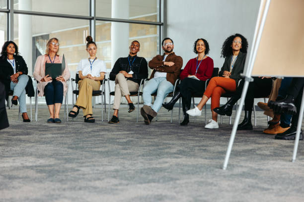 istock Diverse group of people attending a business conference in a modern office setting 2157348113