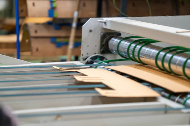 istock Cardboard on a machine production line, texture, background for graphics It is factory made cardboard waiting to be packed. 2157352163