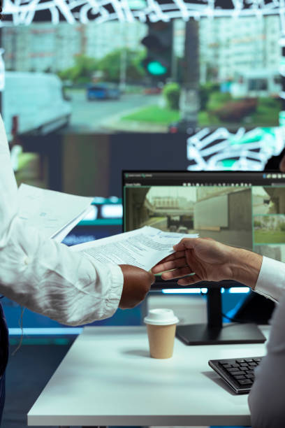 istock Supervisor gives cargo insight papers to indian employee in control center 2157352554