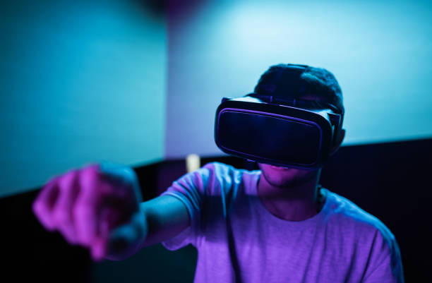istock Man with a VR headset making various hand movements in the air 2157354247