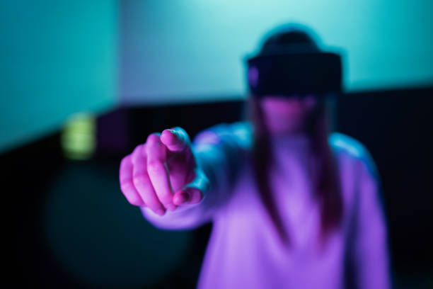 istock Girl in a virtual reality headset making hand gestures in the air 2157354406