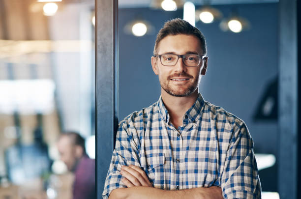 istock Confident, business and man for portrait in office, designer and expert with commitment of creative project. Serious, male person and arms crossed with pride, idea and planning for startup agency 2157354694