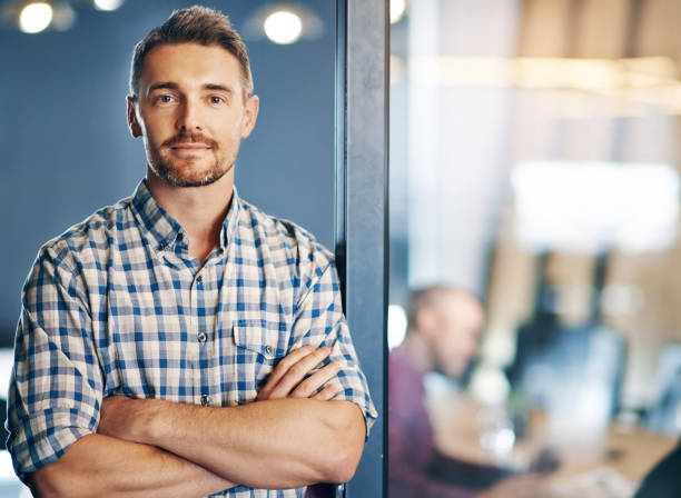 istock Business, man and confident for portrait in office, designer and expert with commitment of creative project. Serious, male person and arms crossed with pride, idea and planning for startup agency 2157354707