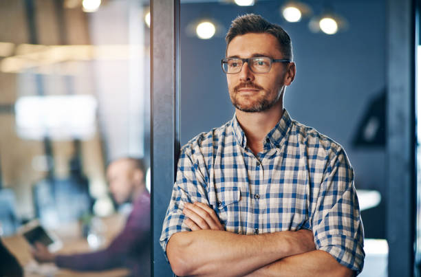 istock Confident, business and thinking man in office with glasses for ideas, planning and insight for startup company . Male person, contemplating and arms crossed for brainstorming opportunity of project 2157354708