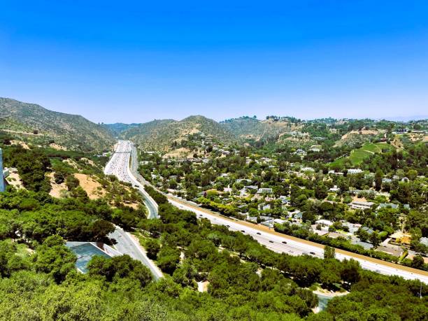 istock Journey through the Peaks: Freeway Beneath Mountain Majesty 2157355269