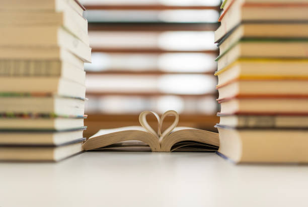 istock Heart shape made from book pages, Books in library 2157356351