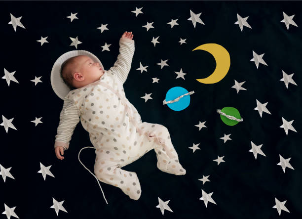istock Baby, sleeping and stars on blanket for nap as top view with space dreaming, comfortable or tired. Child, resting and rest on comforter with planets as future astronaut for development, home or peace 2157356448