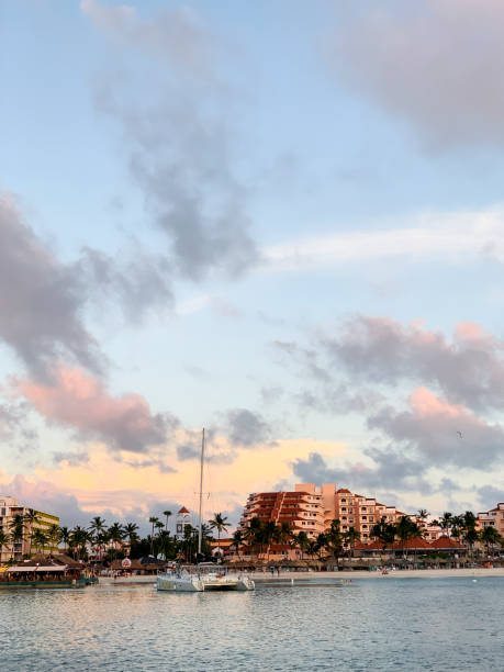 Oranjestad, Aruba -- November 24, 2022: Sunset at the Playa Linda Beach. View from water. Playa Linda beach is known for its white sand and warm water for swimming and snorkeling.