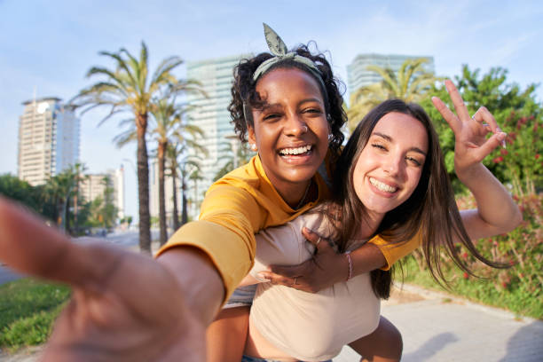 istock two women are taking a selfie together in a park 2157360642