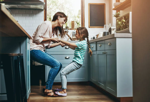 istock Playful, daughter and mom with fun in kitchen for weekend bonding, humor and support in childhood. Happy, smile and woman with little girl at family home for care, funny joke and love in motherhood 2157361782