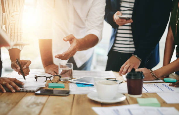 istock Strategy, meeting and hands on documents for business report or financial statement for creative startup. People, paperwork and planning for project target, goals or research analysis in office 2157362752