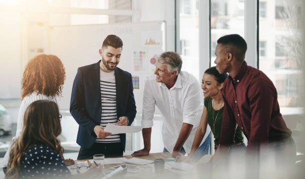 istock People, creative and business discussion in office, documents and collaboration together for brainstorming. Planning, company and goals or strategy idea with professionals in meeting with employees 2157362753