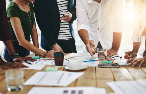 istock Strategy, planning and hands on documents for business report or financial statement for creative startup. People, paperwork and meeting for project target, goals or research analysis in office 2157362754