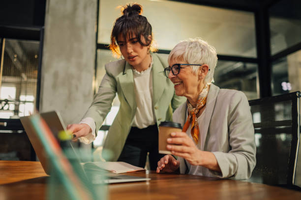 istock Female colleagues with laptop collaborating on a business planning. 2157364631