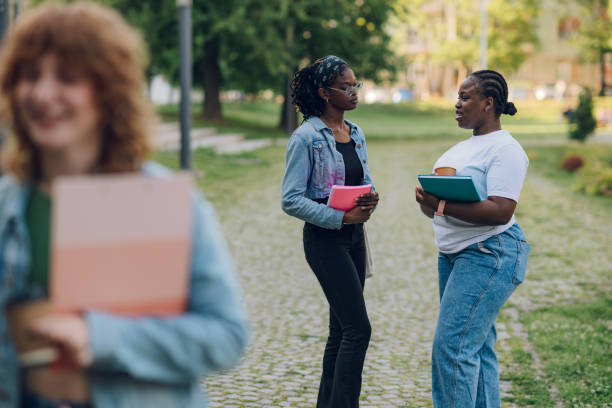 istock Interracial college students at university campus on a break talking. 2157364642
