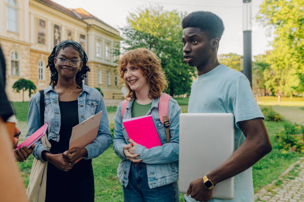 istock Diverse group of exchange students with laptop and textbooks on a break 2157364646