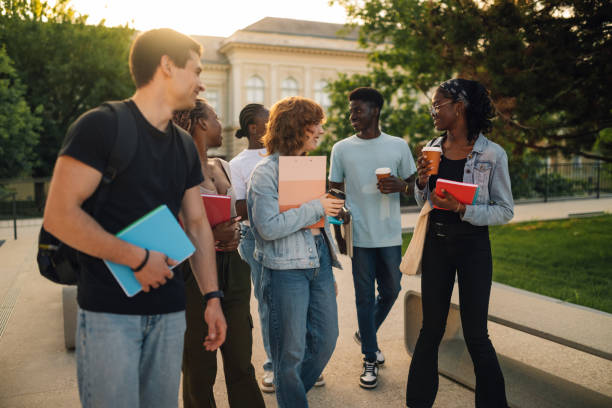 istock Diverse group of students at campus walking and talking after lectures 2157364659