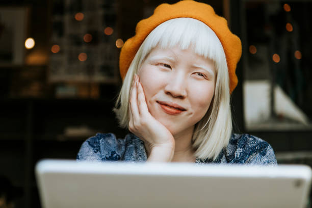 istock Cool asian albino girl using a tablet at a cafe 2157367579