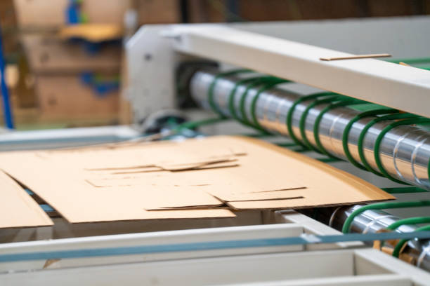 istock Cardboard on a machine production line, texture, background for graphics It is factory made cardboard waiting to be packed. 2157368406