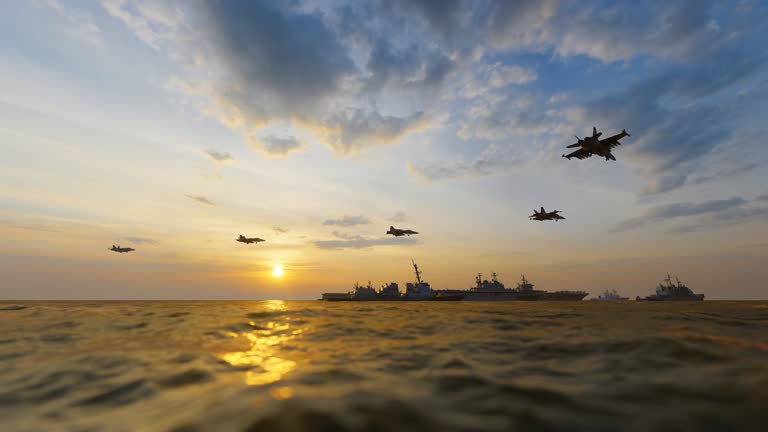 Aerial photography of aircraft carrier battle group at sea at sunset