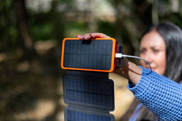 istock Woman using a portable solar panels on the go with her cellphone 2157368659