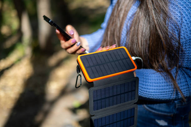 istock Woman using a portable solar panels on the go with her cellphone 2157368784