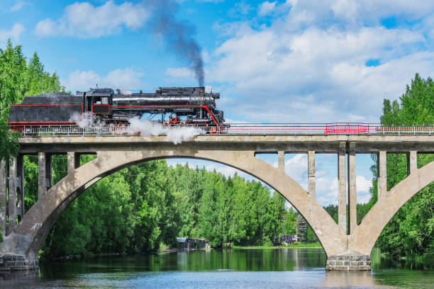 istock Retro steam train moves above the river. 2157368965
