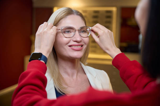 istock Consultant tries on glasses in stylish frame for a client 2157371799