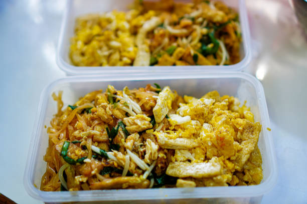 istock Photo of vegetarian Pad Thai in lunch boxes arranged on a kitchen table in a home kitchen. 2157374264