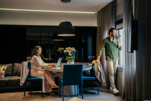 Couple working together in hotel bedroom