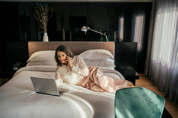 istock Businesswoman working at hotel bedroom 2157374509