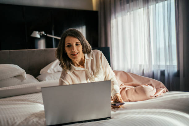 istock Businesswoman working at hotel bedroom 2157374511