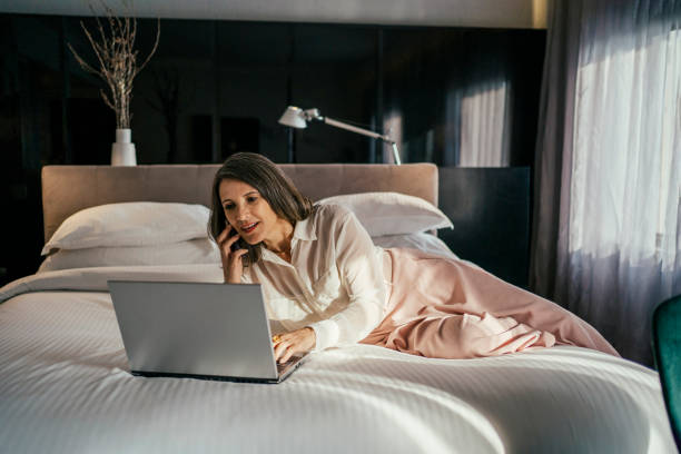 istock Businesswoman working at hotel bedroom 2157374513