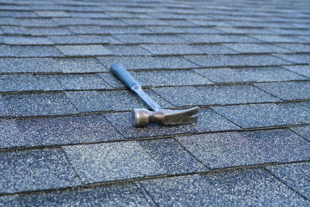 istock close up on hammer on the roof shingle 2157375653