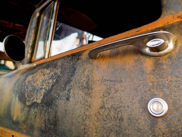 Old Rusted Car Door With Door Handle On A Trailer Ready For Transport. Rust car side view on a trailer.