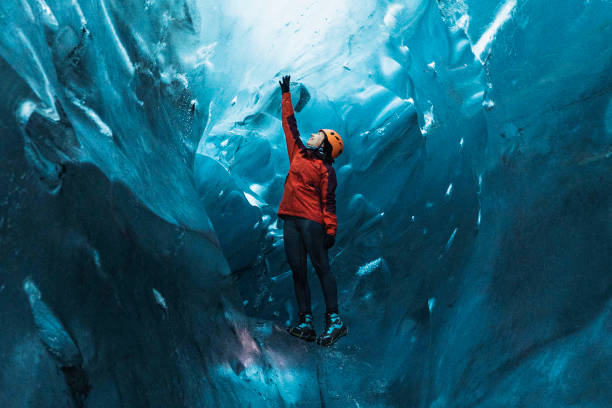 Female explorer in the ice cave, Iceland
